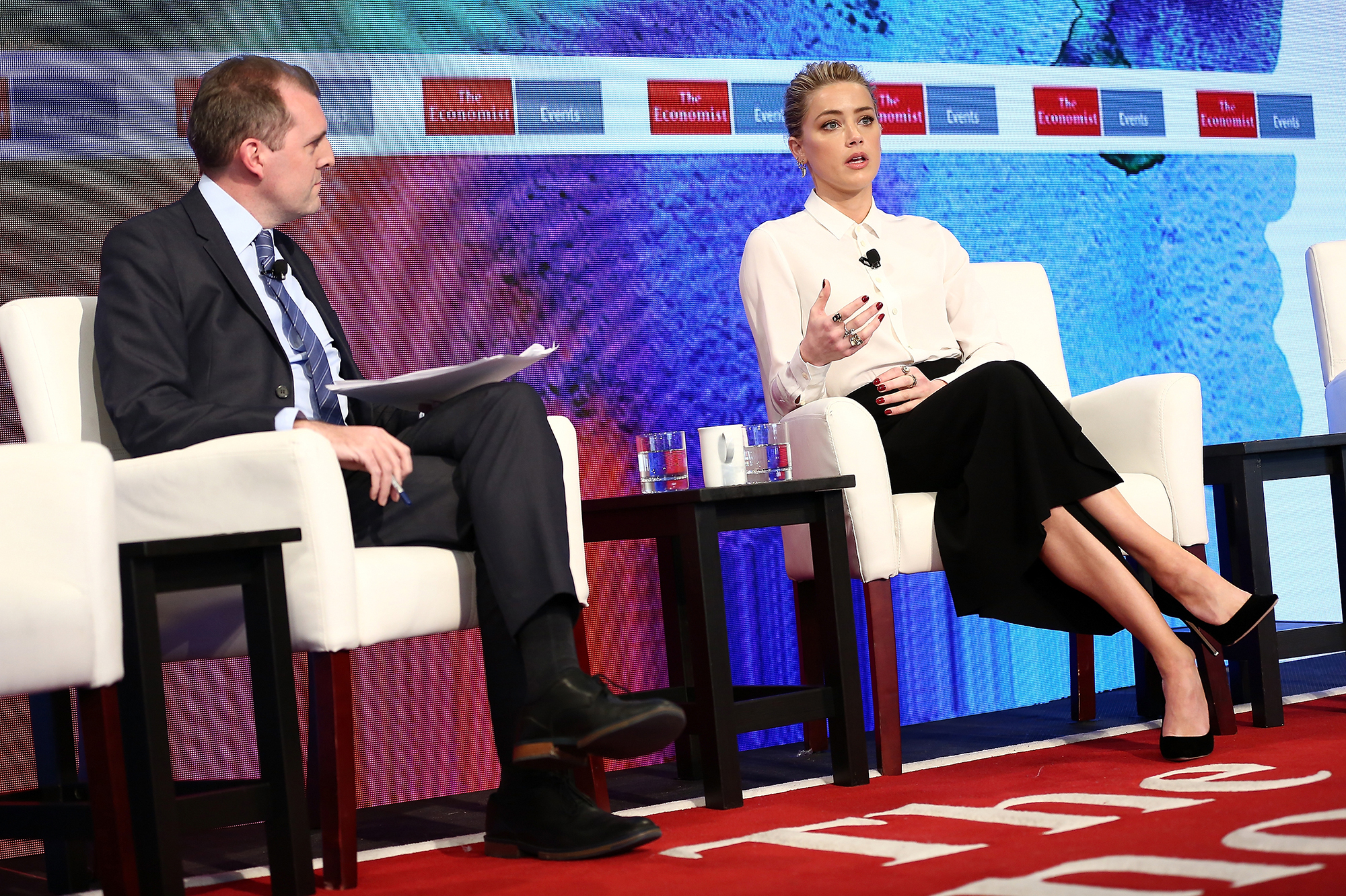 NEW YORK, NY - MARCH 23: Deputy Editor of The Economist Tom Standage (L) speaks with actress Amber Heard during the 2nd Annual Pride & Prejudice Summit at 10 on The Park on March 23, 2017 in New York City. (Photo by Monica Schipper/WireImage)