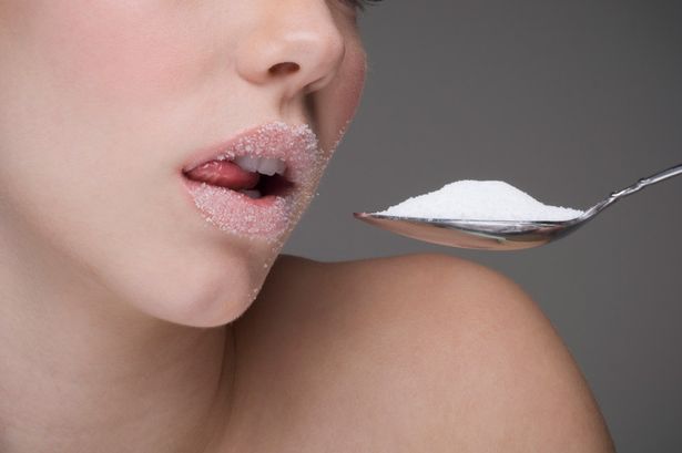 Woman-eating-spoon-of-sugar