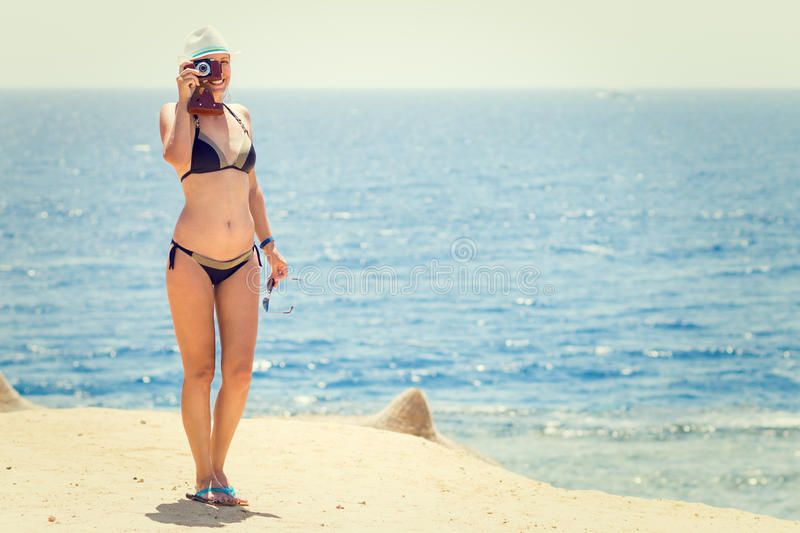 young-slim-woman-old-camera-taking-photo-beach-near-sea-ocean-smiling-girl-bikini-having-fun-summer-59067885