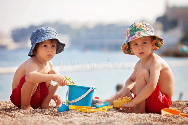 two-cute-kids-playing-sand-beach-summertime-96191462