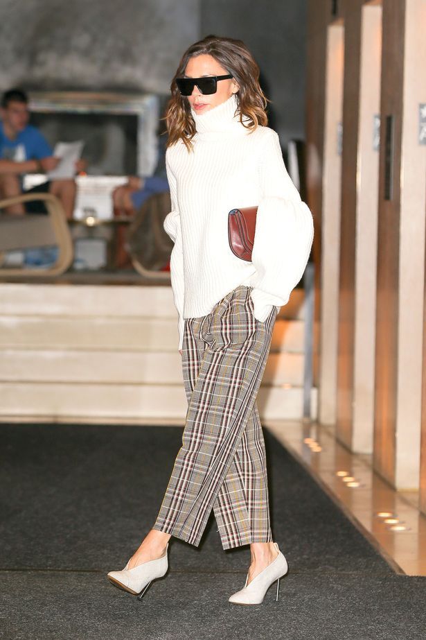 Victoria-Beckham-wore-plaid-tan-pants-with-her-own-design-white-bell-sleeved-sweater-in-New-York-Cit