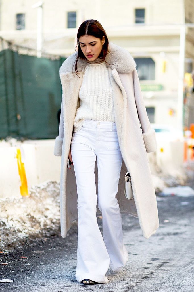 Le-Fashion-Blog-Street-Style-Fashion-Week-Neutrals-Long-Shearling-Coat-Ribbed-Sweater-White-Flared-Jeans-Via-Harpers-Bazaar