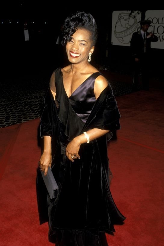 Angela Bassett in a black dress.