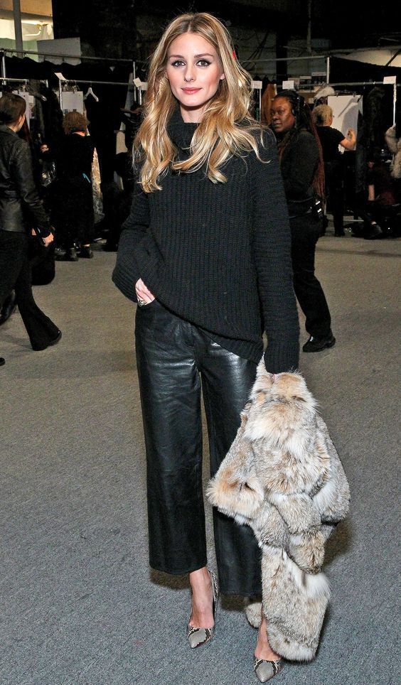 Olivia-Palermo-wearing-cropped-black-leather-pants-a-black-sweater-a-faux-fur-waistcoat-and-snake-print-shoes